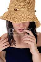 Mysterious woman with big straw hat in close up