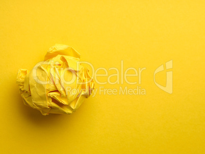 Creativity concept with crumpled yellow paper