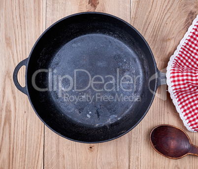 empty black round frying pan and red kitchen napkin
