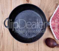 empty black round frying pan and red kitchen napkin