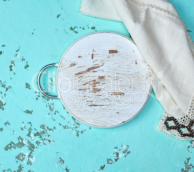 round chopping board on a green background