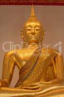 Close-up of golden Buddha in meditative pose