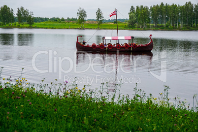 Old wooden viking boat in river