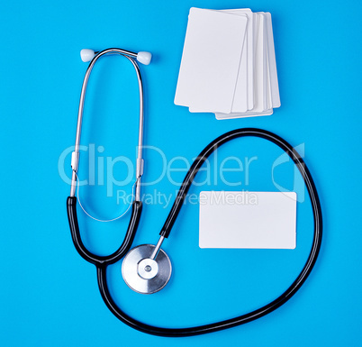 medical stethoscope and empty paper business cards