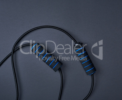 black sports jump rope on a black background