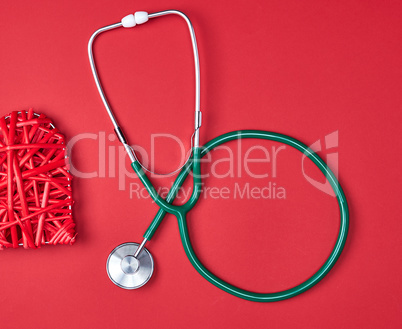 green medical stethoscope  on red background