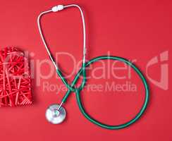 green medical stethoscope  on red background