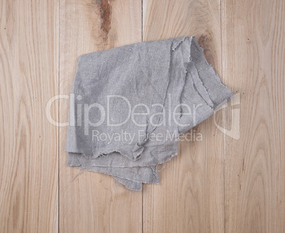 folded gray towel on brown wooden background