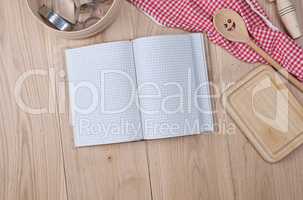 blank open notebook  and wooden kitchen accessories, recipe conc