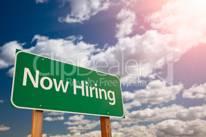 Now Hiring Green Road Sign Aginst Sky