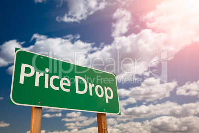 Price Drop Green Road Sign Aginst Sky
