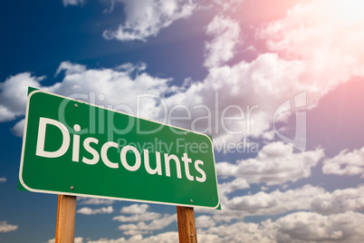 Discounts Green Road Sign Aginst Sky
