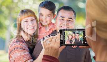 Woman Taking Pictures of A Mixed Race Family with Her Smart Phon