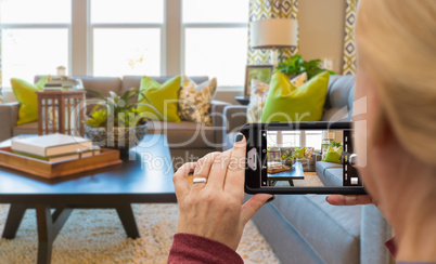 Woman Taking Pictures of A Living Room in Model Home with Her Sm
