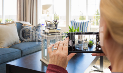 Woman Taking Pictures of A Living Room in Model Home with Phone