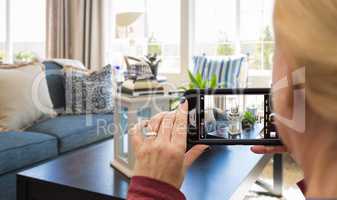Woman Taking Pictures of A Living Room in Model Home with Phone