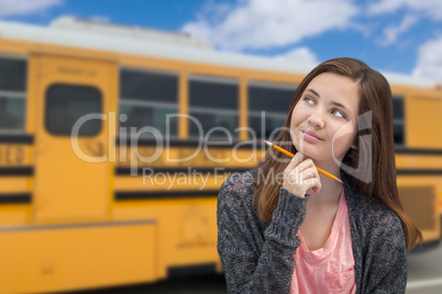 Young Female Teen Student Near School Bus