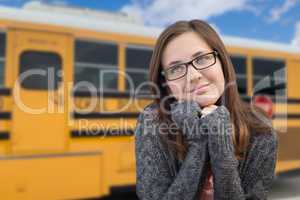 Young Female Teen Student Near School Bus