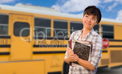 Young Female Student Near School Bus