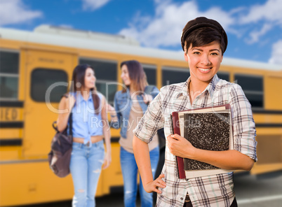 Young Mixed Race Female Students Near School Bus