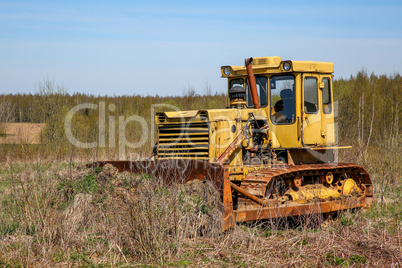 Old crawler tractor in the field.