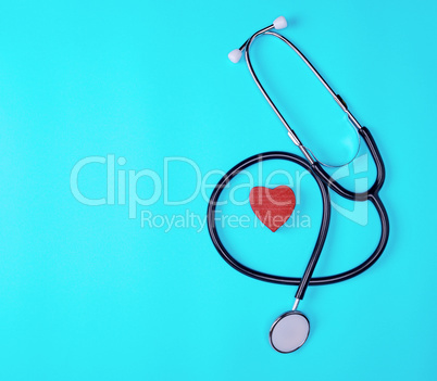 medical stethoscope and red wooden heart