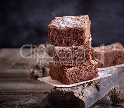 stack of square pieces of baked brown brownie pie