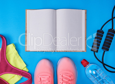 open notebook with empty white sheets, sportswear for fitness