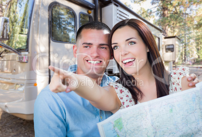 Young Military Couple Looking at Map In Front of RV