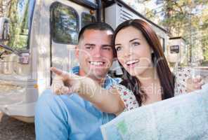 Young Military Couple Looking at Map In Front of RV