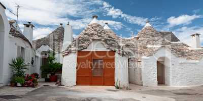 Some Trulli houses in a street of Alberobello, Puglia, Italy