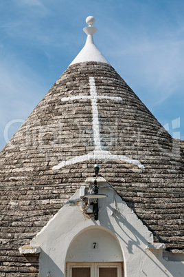 Symbol in the Trullo conical rooftop in Alberobello, Apulia, Ita