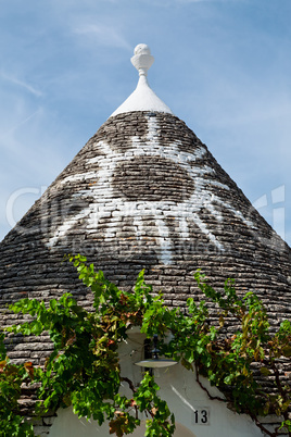 Symbol in the Trullo conical rooftop in Alberobello, Puglia, Ita