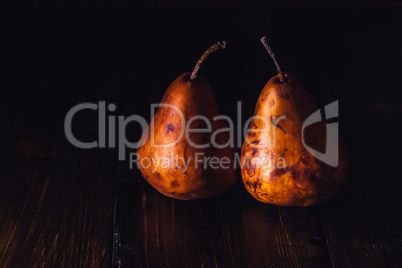 Two Golden Pears on Table