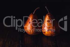 Two Golden Pears on Table