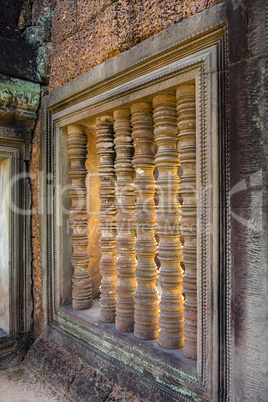 Stone pillar window decor in Banteay Samre temple in Cambodia
