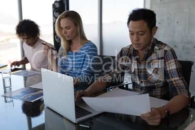 Executives working at table in office