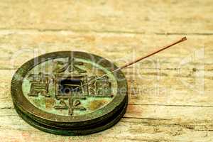 acupuncture needle on antique Chinese coin