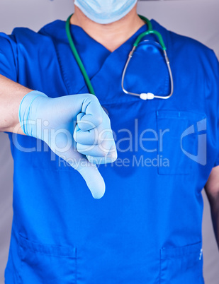 doctor in blue uniform and latex sterile gloves shows a gesture