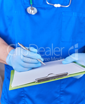 doctor in blue uniform holds a pen and paper holder