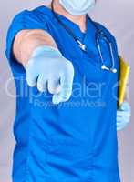 doctor in blue uniform and latex gloves showing hand gesture