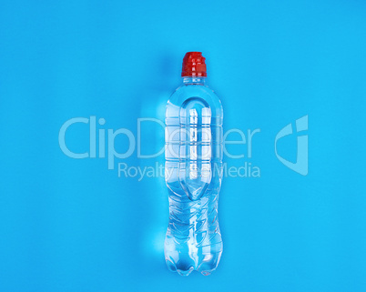 transparent plastic bottle with fresh water on a blue background