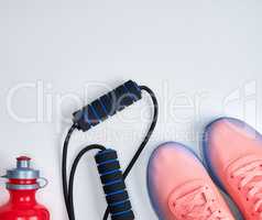 pair of pink sneakers with laces on a white background