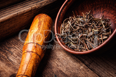 Dried rosemary on wooden background