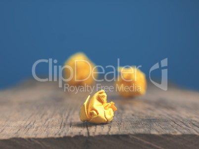 Three yellow paper balls on a table