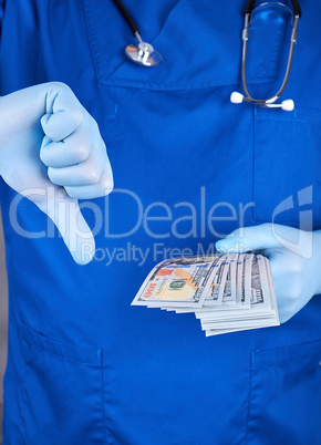 doctor in blue uniform and latex gloves keeps one hand a lot of