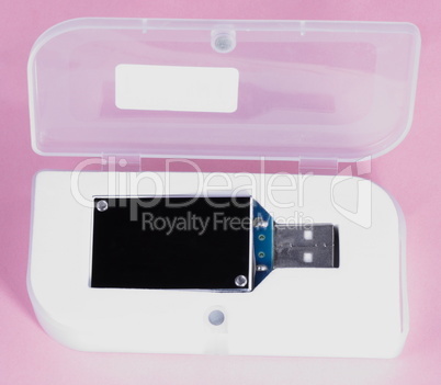 electronic device in plastic case on pink background at day