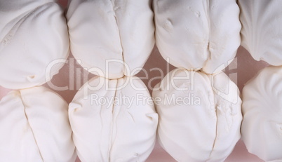 many white marshmallow on pink background at dry day