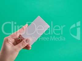 white paper business card in a female hand