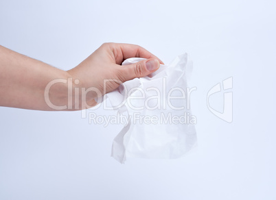 female hand holding a clean white paper napkin for face and body